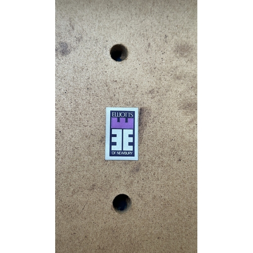 37C - A mid 20th century Elliotts of Newbury teak circular drop leaf dining table and four black vinyl cha... 