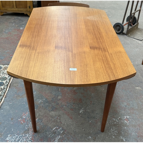 37C - A mid 20th century Elliotts of Newbury teak circular drop leaf dining table and four black vinyl cha... 
