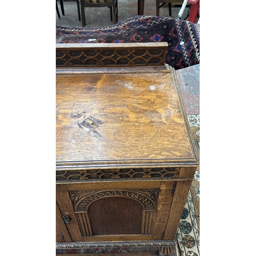 38 - An early 20th century carved oak sideboard on baluster supports - approx. 102cm high x 137cm wide x ... 