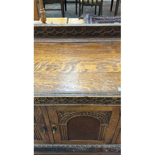 38 - An early 20th century carved oak sideboard on baluster supports - approx. 102cm high x 137cm wide x ... 