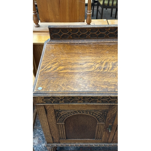 38 - An early 20th century carved oak sideboard on baluster supports - approx. 102cm high x 137cm wide x ... 