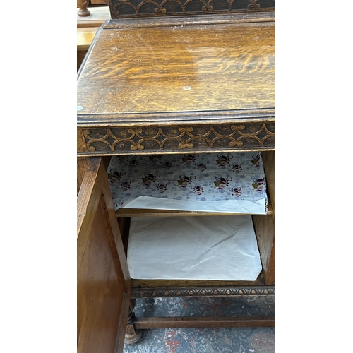 38 - An early 20th century carved oak sideboard on baluster supports - approx. 102cm high x 137cm wide x ... 