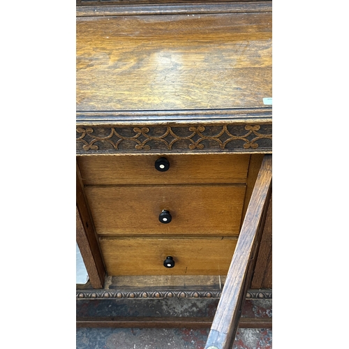 38 - An early 20th century carved oak sideboard on baluster supports - approx. 102cm high x 137cm wide x ... 