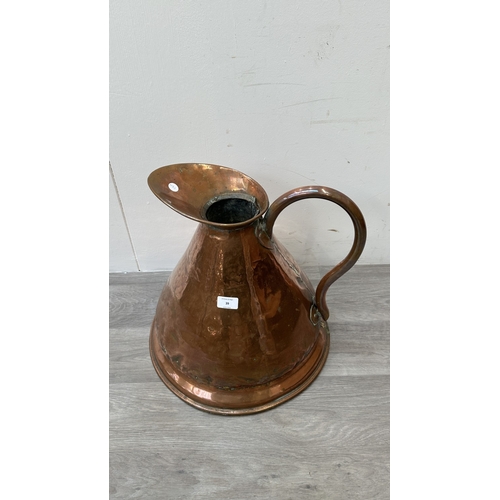 39 - A 19th century copper measuring jug - approx. 41cm high