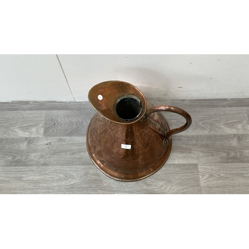 39 - A 19th century copper measuring jug - approx. 41cm high