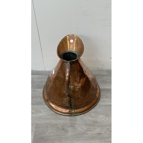 39 - A 19th century copper measuring jug - approx. 41cm high