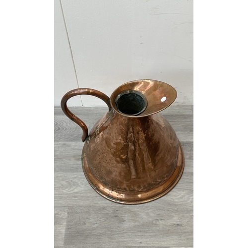 39 - A 19th century copper measuring jug - approx. 41cm high