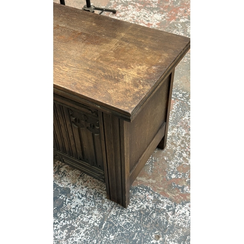 4 - A 17th century style carved oak linenfold blanket box - approx. 52cm high x 99cm wide x 40cm deep