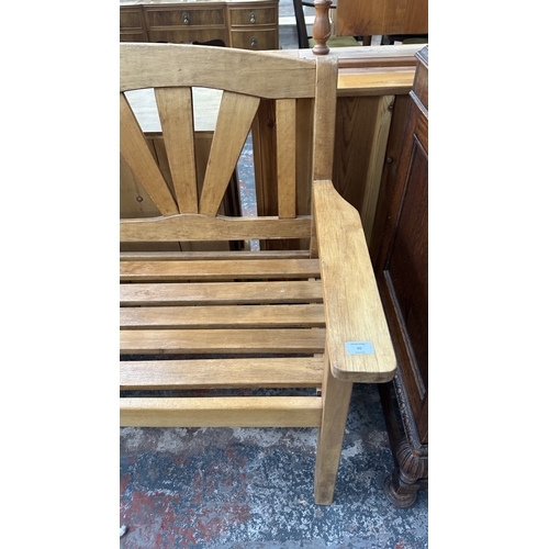 40 - A teak garden bench - approx. 92cm high x 131cm wide x 60cm deep