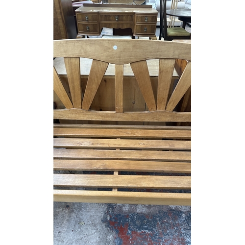 40 - A teak garden bench - approx. 92cm high x 131cm wide x 60cm deep