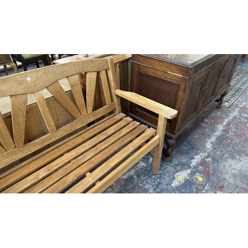 40 - A teak garden bench - approx. 92cm high x 131cm wide x 60cm deep