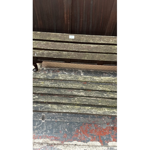 41 - A Victorian style cast metal and wooden slatted garden bench - approx. 68cm high x 122cm wide x 49cm... 