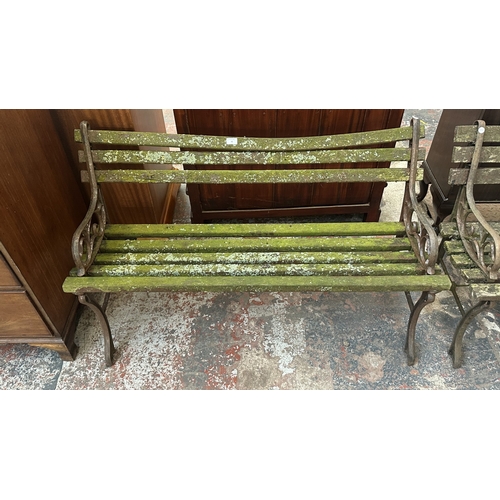 42 - A Victorian style cast metal and wooden slatted garden bench - approx. 68cm high x 122cm wide x 49cm... 