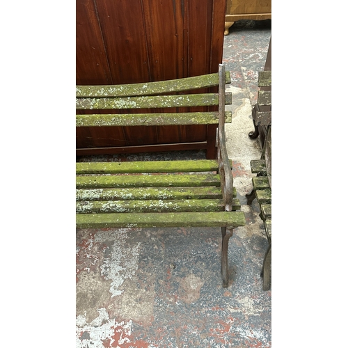 42 - A Victorian style cast metal and wooden slatted garden bench - approx. 68cm high x 122cm wide x 49cm... 