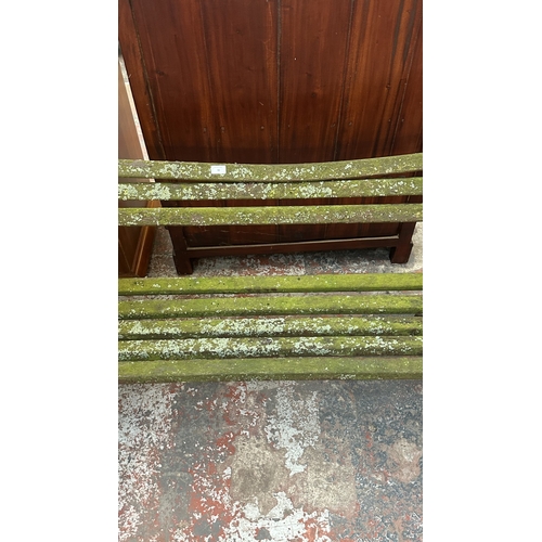 42 - A Victorian style cast metal and wooden slatted garden bench - approx. 68cm high x 122cm wide x 49cm... 