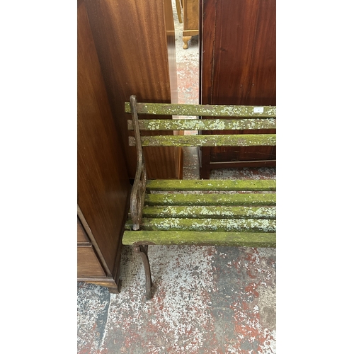42 - A Victorian style cast metal and wooden slatted garden bench - approx. 68cm high x 122cm wide x 49cm... 