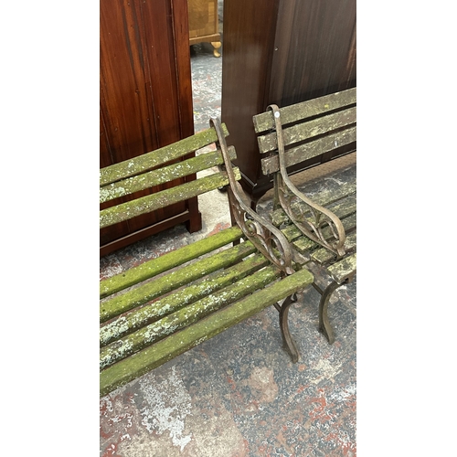 42 - A Victorian style cast metal and wooden slatted garden bench - approx. 68cm high x 122cm wide x 49cm... 