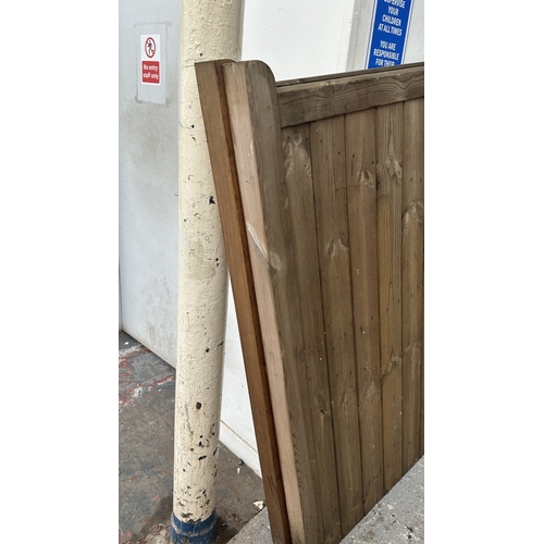 43 - A pair of tanalised timber driveway gates - approx. 144cm high x 134cm wide