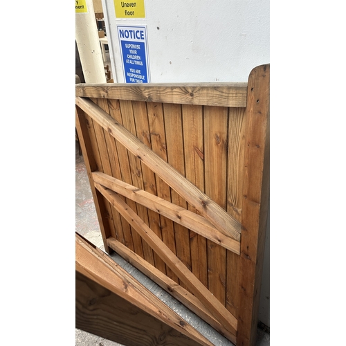 43 - A pair of tanalised timber driveway gates - approx. 144cm high x 134cm wide