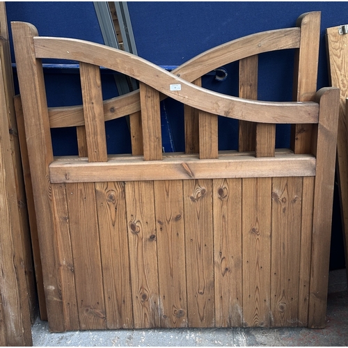 45 - A pair of tanalised timber arched top driveway gates - approx. 124cm high x 113cm wide