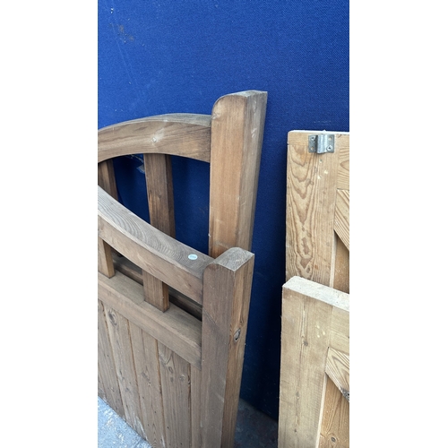 45 - A pair of tanalised timber arched top driveway gates - approx. 124cm high x 113cm wide
