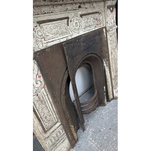 48 - A Victorian white painted cast iron fire surround with two inserts - approx. 126cm high x 136cm wide... 