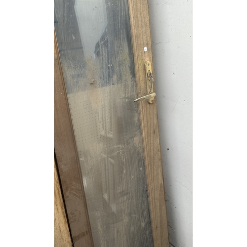 54 - A pair of wooden glazed conservatory doors with frame - approx. 236cm high x 122cm wide including fr... 