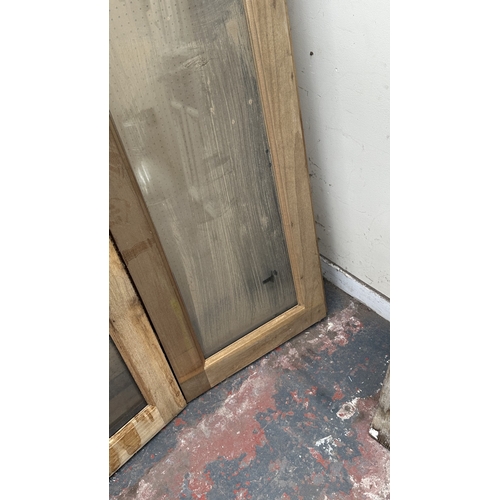 54 - A pair of wooden glazed conservatory doors with frame - approx. 236cm high x 122cm wide including fr... 
