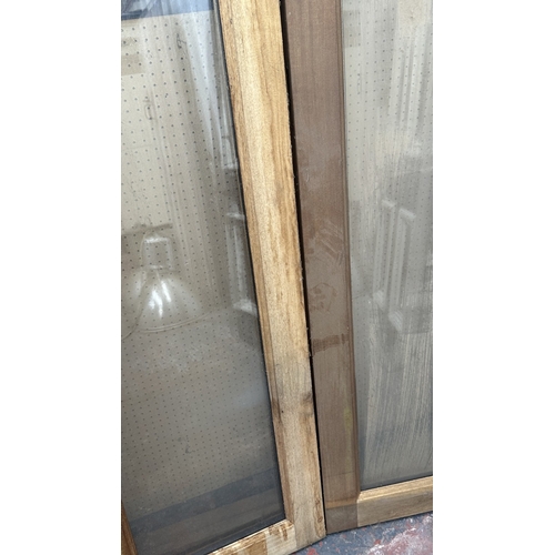 54 - A pair of wooden glazed conservatory doors with frame - approx. 236cm high x 122cm wide including fr... 