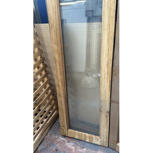 54 - A pair of wooden glazed conservatory doors with frame - approx. 236cm high x 122cm wide including fr... 