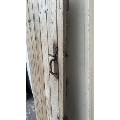 57 - A vintage wooden exterior door with metal hinges and latch - approx. 192cm high x 74cm wide