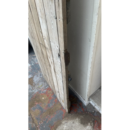 57 - A vintage wooden exterior door with metal hinges and latch - approx. 192cm high x 74cm wide