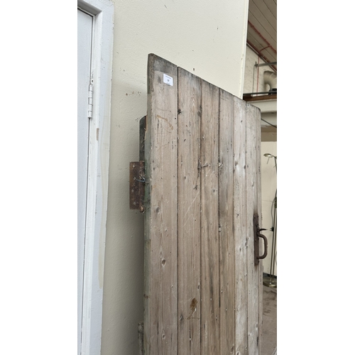 57 - A vintage wooden exterior door with metal hinges and latch - approx. 192cm high x 74cm wide