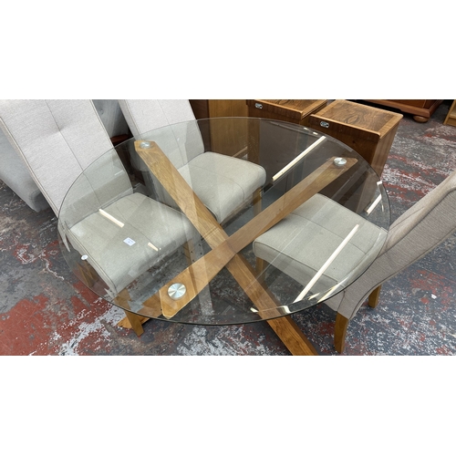 6 - A modern oak and glass top circular dining table and four grey fabric upholstered chairs - approx. 7... 
