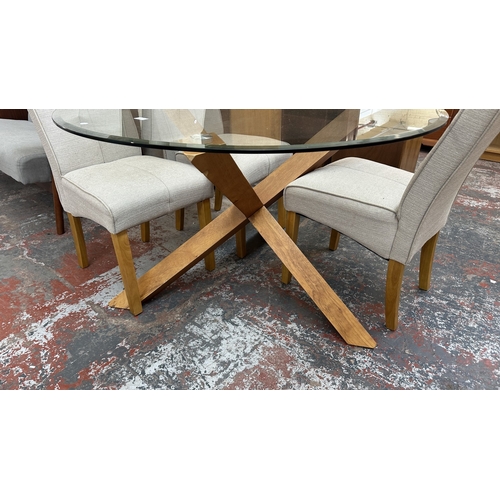 6 - A modern oak and glass top circular dining table and four grey fabric upholstered chairs - approx. 7... 