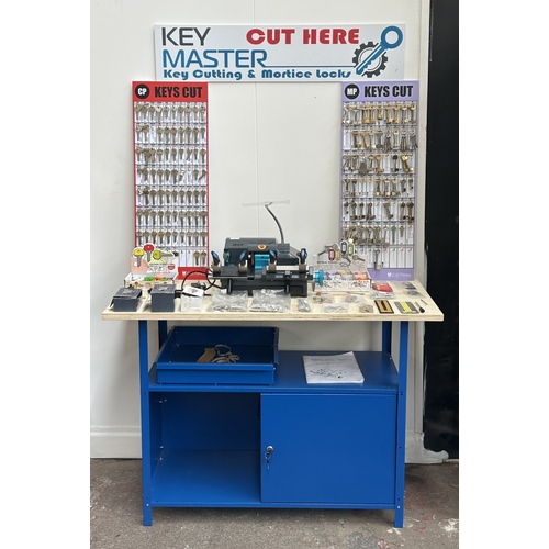 63 - An RST TM800 cylinder and mortice key cutting machine with a large quantity of keys, accessories and... 