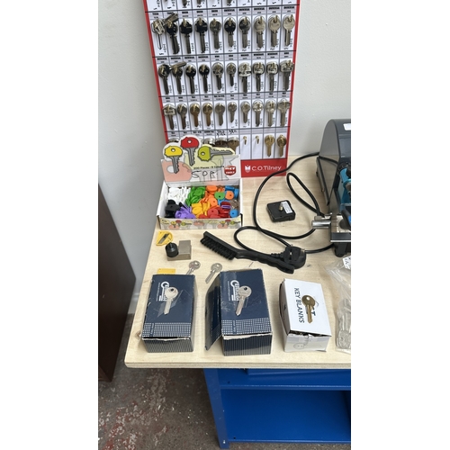 63 - An RST TM800 cylinder and mortice key cutting machine with a large quantity of keys, accessories and... 