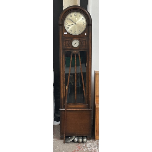 63A - An Art Deco oak cased grandfather clock with fitted British made aneroid barometer, pendulum and thr... 