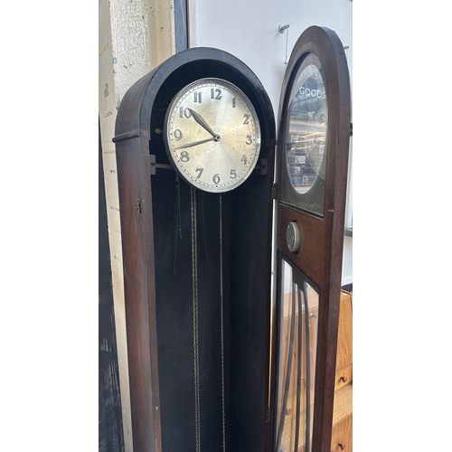 63A - An Art Deco oak cased grandfather clock with fitted British made aneroid barometer, pendulum and thr... 