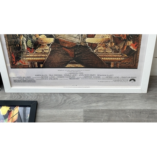 63C - Three framed reproduction prints, one Robert De Niro Taxi Driver, one Raiders of the Lost Ark and on... 