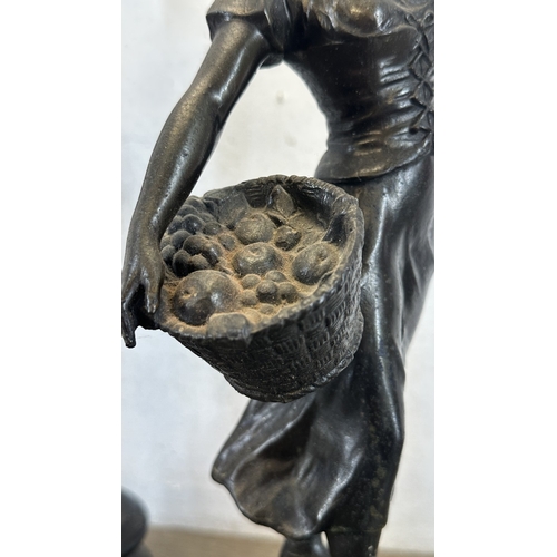 69 - Two French bronzed spelter figurines on ebonised plinths, one titled 'La Paysanne' and one titled 'L... 