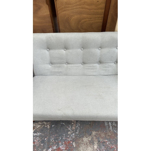 7 - A WarmieHomy grey button back fabric upholstered and stained beech two seater sofa - approx. 75cm hi... 