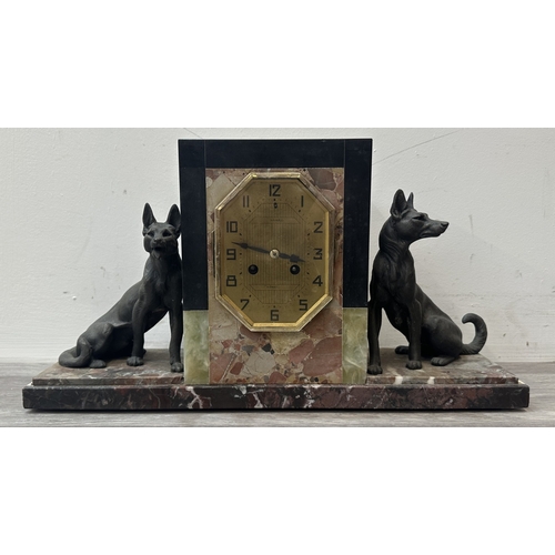 75 - An Art Deco French marble and onyx mantel clock featuring two spelter German Shepherd dog figurines ... 
