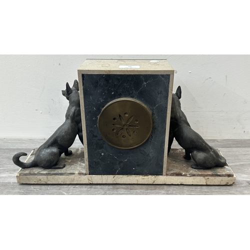 75 - An Art Deco French marble and onyx mantel clock featuring two spelter German Shepherd dog figurines ... 