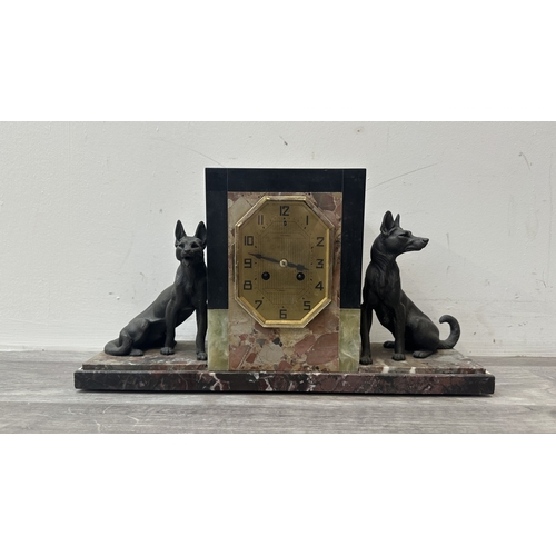 75 - An Art Deco French marble and onyx mantel clock featuring two spelter German Shepherd dog figurines ... 