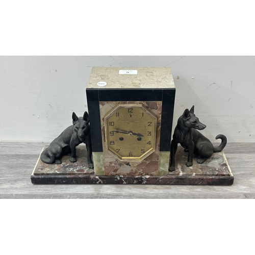 75 - An Art Deco French marble and onyx mantel clock featuring two spelter German Shepherd dog figurines ... 
