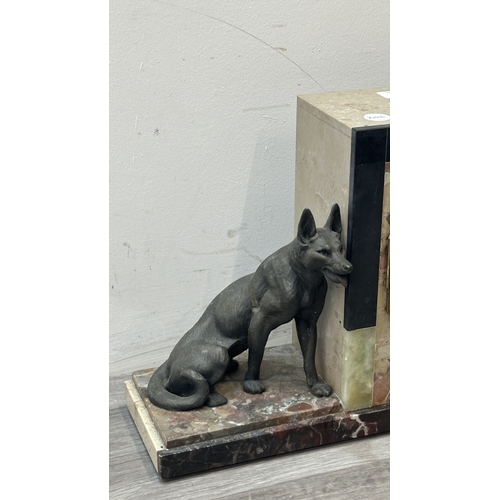 75 - An Art Deco French marble and onyx mantel clock featuring two spelter German Shepherd dog figurines ... 