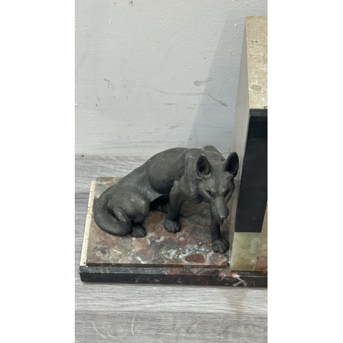 75 - An Art Deco French marble and onyx mantel clock featuring two spelter German Shepherd dog figurines ... 