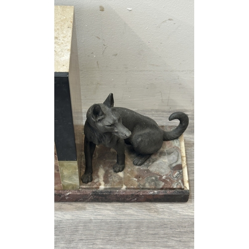 75 - An Art Deco French marble and onyx mantel clock featuring two spelter German Shepherd dog figurines ... 