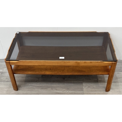 77 - A mid 20th century Myer teak and smoked glass coffee table - approx. 35cm high x 44cm wide x 87cm lo... 